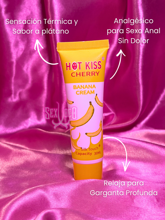 Tubo amarillo de Hot Kiss Banana Cream sobre fondo de satén rosa neón Sex Shop Xoco.